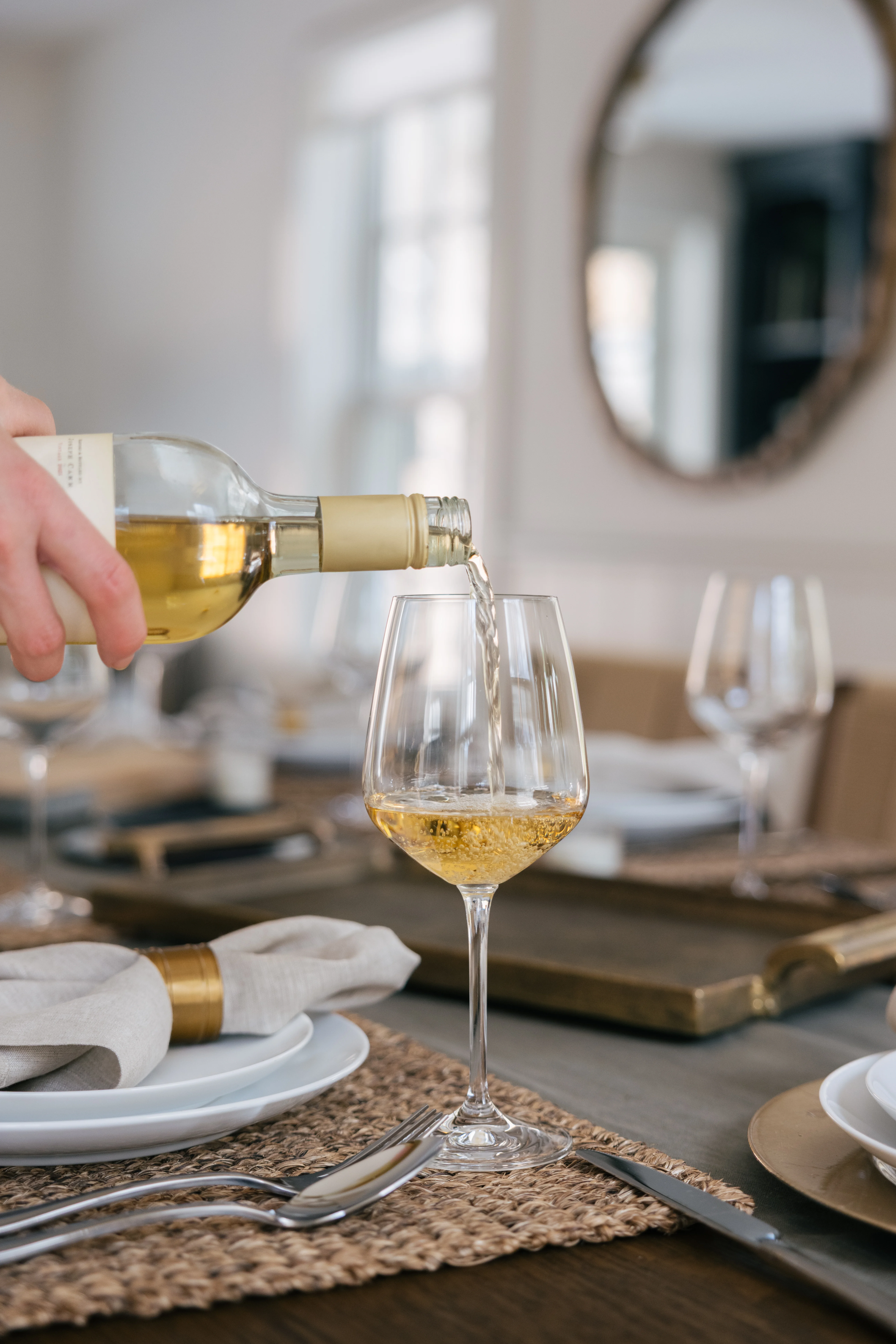Dinner party setting in the dining area with warm lighting and curated decor